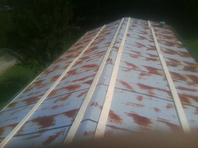 Rusted metal roof panels with new wood purlins before replacement — Storm Damage Roof Repair in Preston by Roofing Brothers